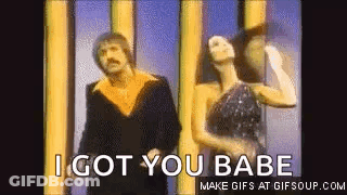 Man And Woman Dancing By I Got You Babe Sign GIF