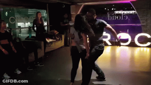 Man And Woman Dancing By Roc Sign GIF