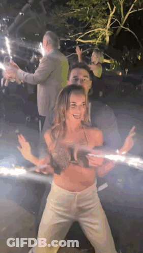 Man And Woman Dancing In Dark Room With Sparklers GIF