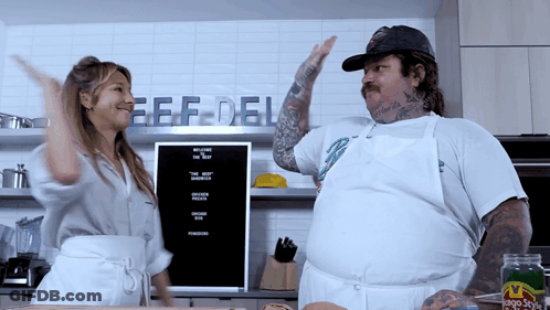 Man And Woman Dancing In Front Of Beef Deli Sign GIF