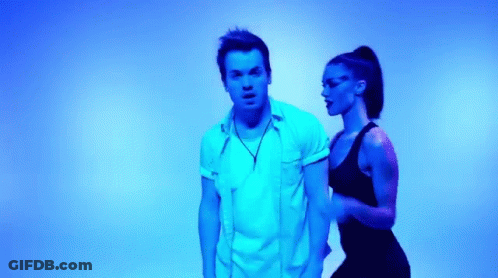 Man And Woman Dancing In Front Of Blue Light GIF