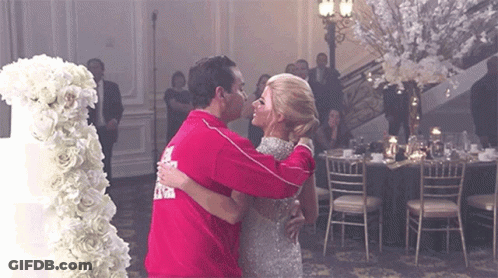 Man And Woman Dancing In Front Of Cake GIF