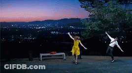 Man And Woman Dancing In Front Of City At Night GIF