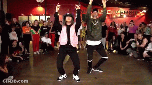 Man And Woman Dancing In Front Of Crowd GIF