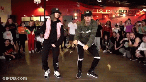 Man And Woman Dancing In Front Of Crowd GIF