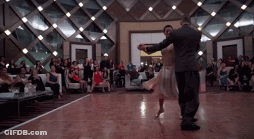 Man And Woman Dancing In Front Of Crowd GIF