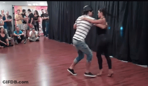 Man And Woman Dancing In Front Of Crowd GIF