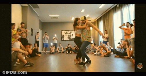 Man And Woman Dancing In Front Of Crowd GIF