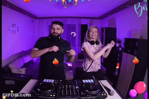 Man And Woman Dancing In Front Of DJ Set GIF