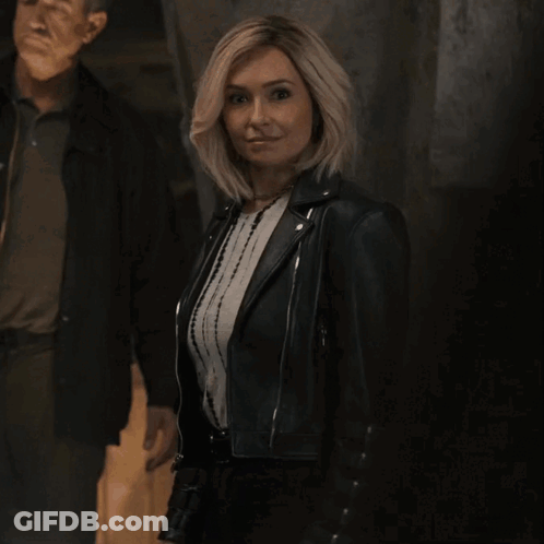 Man And Woman Dancing In Front Of Fast Lake Spartans Chess Team Sign GIF