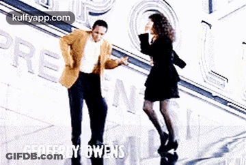 Man And Woman Dancing In Front Of Geoffrey Owens GIF
