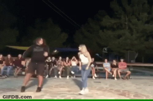 Man And Woman Dancing In Front Of Group GIF