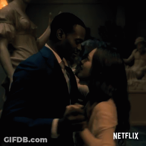 Man And Woman Dancing In Front Of Netflix Sign GIF