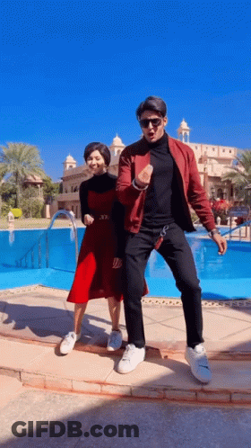 Man And Woman Dancing In Front Of Pool GIF