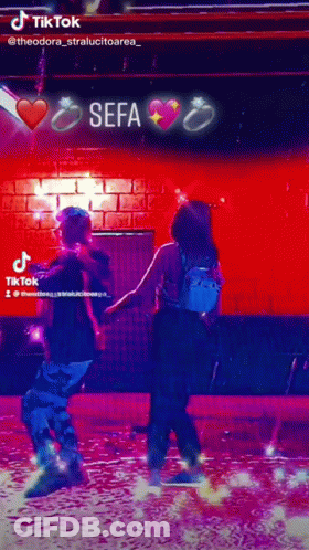 Man And Woman Dancing In Front Of Sefa Sign GIF