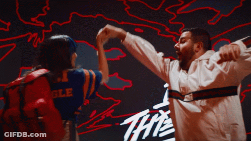 Man And Woman Dancing In Front Of Sign The GIF