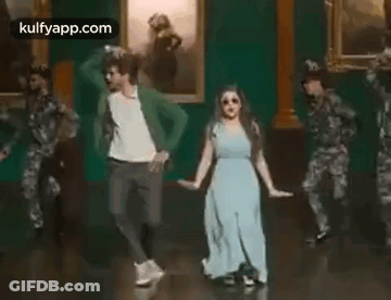 Man And Woman Dancing In Front Of Soldiers GIF