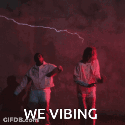 Man And Woman Dancing In Front Of We Vibing Sign GIF