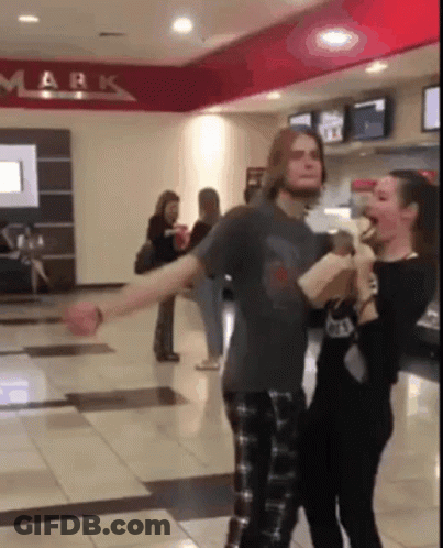 Man And Woman Dancing In Hallway With Mark On Ceiling GIF