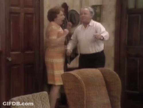 Man And Woman Dancing In Living Room With Chairs GIF