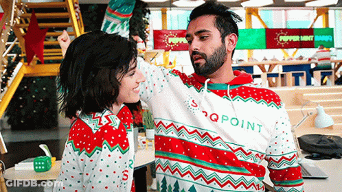 Man And Woman Dancing In Ugly Christmas Sweaters GIF