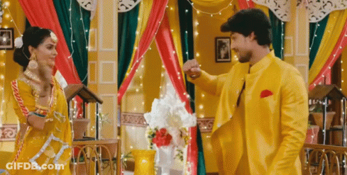 Man And Woman Dancing In Yellow And Red Room GIF