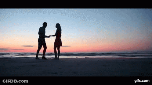 Man And Woman Dancing On Beach At Sunset GIF