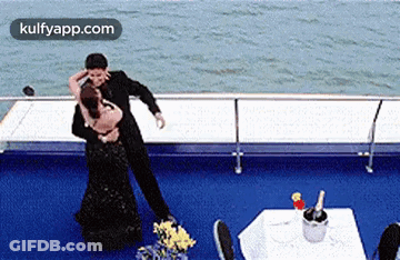 Man And Woman Dancing On Boat With Champagne GIF