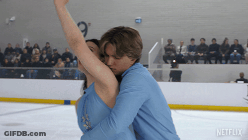Man And Woman Dancing On Ice Rink With Netflix Logo GIF