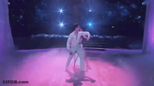 Man And Woman Dancing On Purple Dance Floor GIF