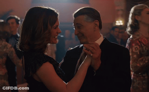 Man And Woman Dancing On Stage In Front Of Record TV Sign GIF