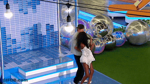 Man And Woman Dancing On Stage With Balloons GIF