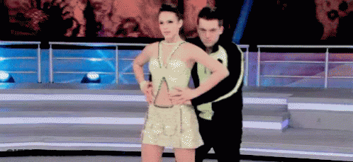 Man And Woman Dancing On Stage, Woman In Gold Dress GIF