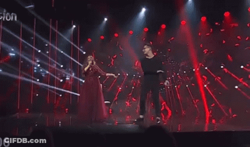 Man And Woman Dancing Singing On Stage GIF