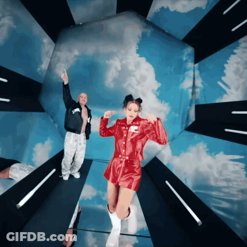 Man And Woman Dancing Under Blue Sky GIF
