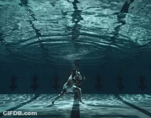 Man And Woman Dancing Underwater With Letter T GIF
