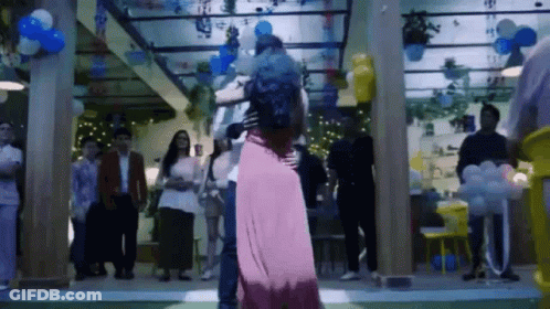 Man And Woman Dancing With Balloons GIF