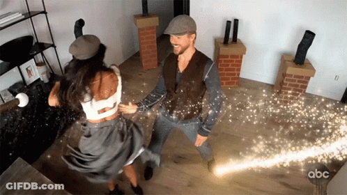 Man And Woman Dancing With Sparks GIF