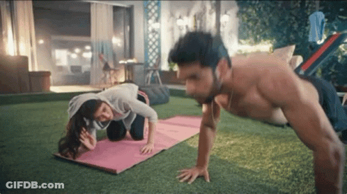 Man And Woman Doing Push Ups In Backyard GIF