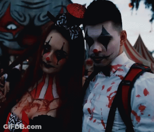 Man And Woman Dressed As Clowns GIF