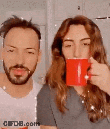 Man And Woman Drinking Coffee From Red Mugs GIF