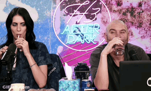 Man And Woman Drinking In Front Of After Dark Sign GIF