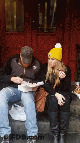 Man And Woman Eating On Steps GIF