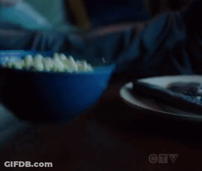 Man And Woman Eating Popcorn On Couch GIF
