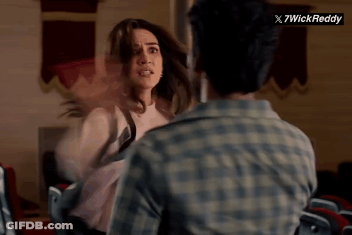 Man And Woman Fighting In Front Of 7Wick Reddy Sign GIF