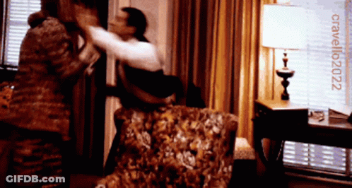 Man And Woman Fighting In Room With Cavallo2022 Sign GIF