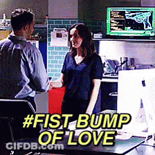 Man And Woman Fist Bump Of Love In Front Of Computer GIF