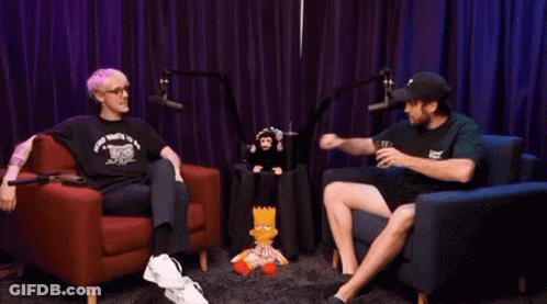 Man And Woman Fist Bumping In Front Of Stuffed Monkey GIF
