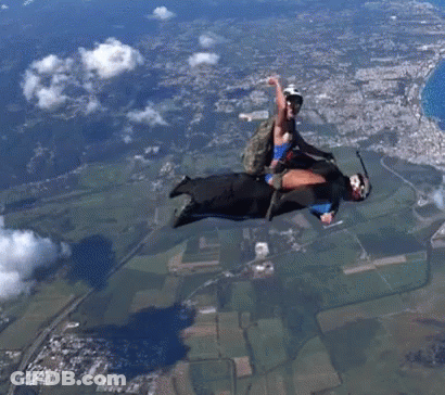 Man And Woman Flying With Parachute GIF