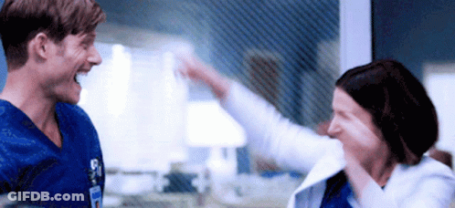 Man And Woman Giving Each Other High Five GIF